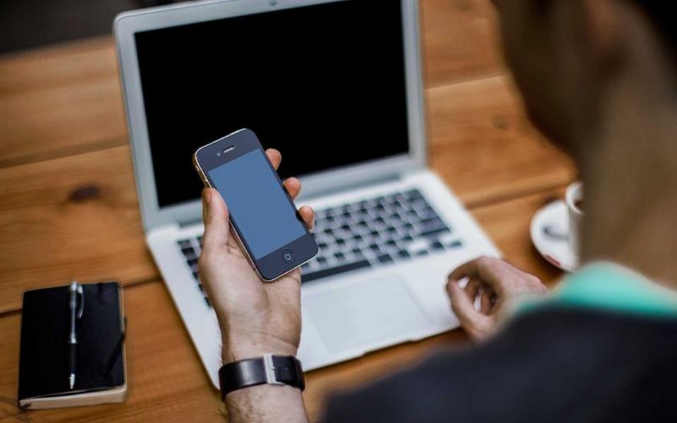A hand holding a smartphone