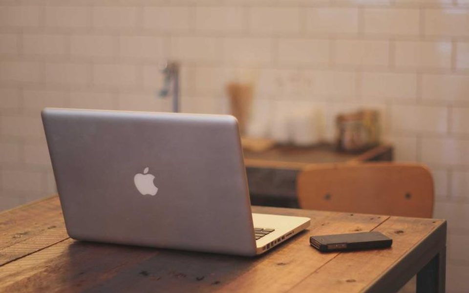 A bright desk with an open laptop